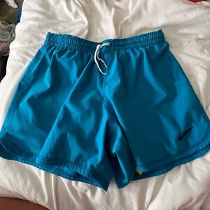 small blue nike shorts with yellow spandex built in